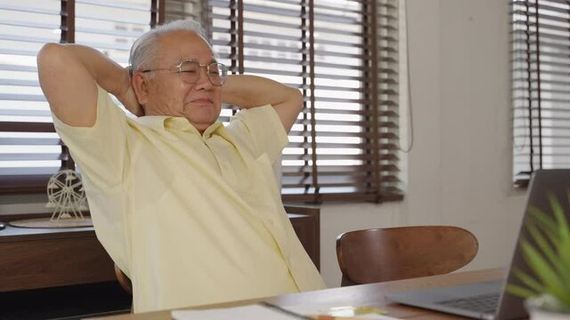 Asian old man Retirement age using tablet computer to transfer money online or financial payment and read text, smile or laugh with happy and positive. Senior asian with digital technology concept.