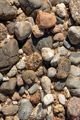 Dry round stones on beach abstract background