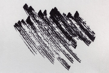 Black paint strokes on a white wall