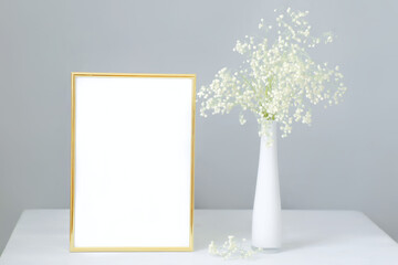 Mock-up frame with bouquet of white gypsophila