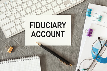 Fiduciary Account is written in a document on the office desk
