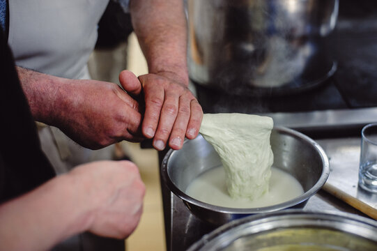 The home-made cheese maker produces handmade mozzarella with fresh quality milk. Concept: tradition, italy, mozzarella.The process of making mozzarella. Film noise.