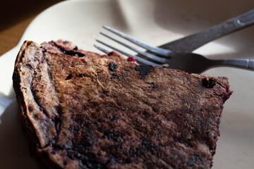 pancake with black berries lying on a plate