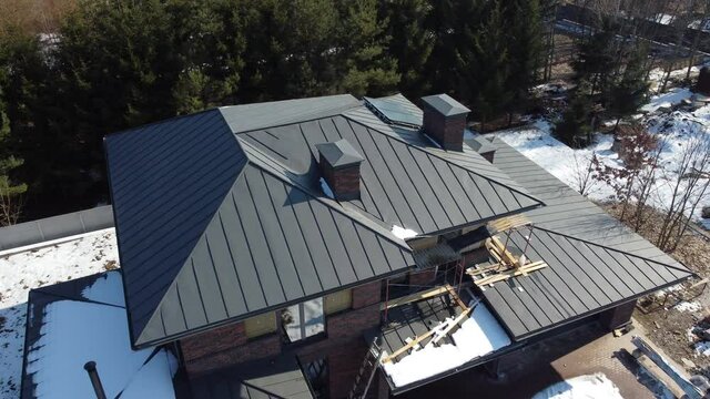 Aerial top view of new modern residential house cottage water heat system on roof. Renewable ecological green energy production concept.