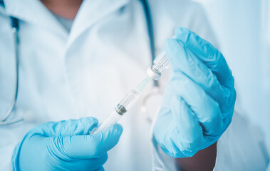 Doctor with syringe ready for injection of vaccine to patient. Vaccination concept..