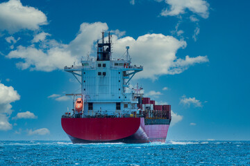 Cargo shipping transportation logistic commerce industry loading export on sea with blue cloud sky background.
