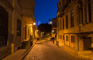 ancient narrow street at night with lights 