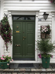 door with flowers in front of house