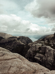 rocks in the mountains. clouds over the mountains. canyon. fjord. view from the top of mountain