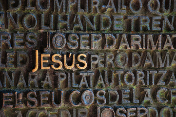 Word Jesus on bronze Gospel door of Passion facade of Sagrada Familia basilica. Barcelona, Spain....