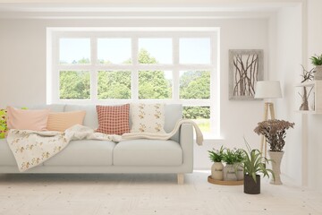 White living room with sofa and summer landscape in window. Scandinavian interior design. 3D illustration