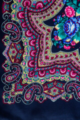 top view closeup part of floral and paisley pattern on dark cotton scarf