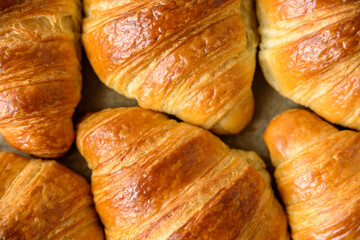 Fresh baked puff pastry croissants on baking paper