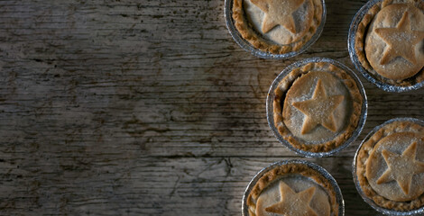 Obraz na płótnie Canvas Flat Lay Photo of Some British Mince Pies on a Wooden Textured Background With Copy Space