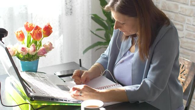 Business woman typing on laptop computer working at home using  internet. Female professional working notebook at home 