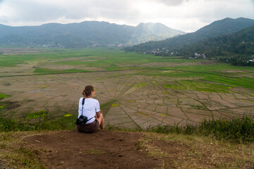 Fototapeta na wymiar Young hiker in the spider rice field terraces in Flores Indonesia 