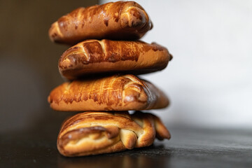 Appetizing fresh homemade buns on a wooden background, close-up.