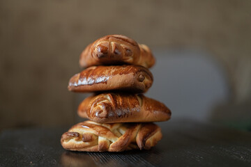 Appetizing fresh homemade buns on a wooden background, close-up.