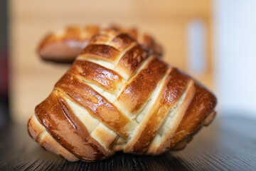 Appetizing fresh homemade buns on a wooden background, close-up.