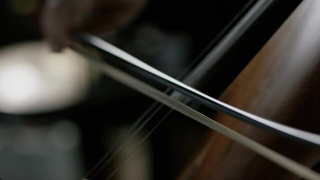 The cellist performs on stage.