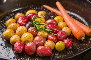 Small colorful potatoes in a skillet cast iron pan