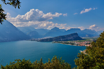 Panoramic view on Lake Garda from the Busatte-Tempesta trail near Nago-Torbole with the iron staircase,  Torbole  town surrounded by mountains in the summer time,Italy