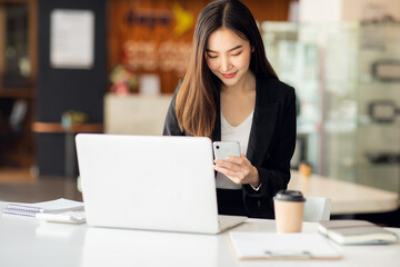 Portrait of Asian young female working on laptop at office