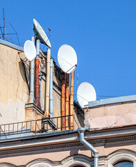 Satellite dishes mounted on the wall of house