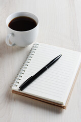 Notepad and pen with coffee