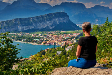 Naklejka na ściany i meble Panoramic view on Lake Garda from the Busatte-Tempesta trail near Nago-Torbole with the iron staircase, Torbole town surrounded by mountains in the summer time,Italy