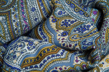 top view closeup on crumpled soft cotton scarf with bright oriental ornament