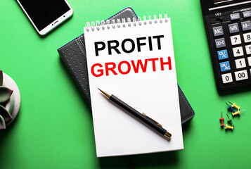 On a green background - a telephone, a calculator and a diary with the inscription PROFIT GROWTH
