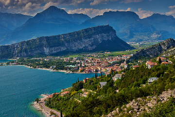 Panoramic view on Lake Garda from the Busatte-Tempesta trail near Nago-Torbole with the iron staircase,  Torbole  town surrounded by mountains in the summer time,Italy
