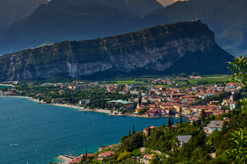 Panoramic view on Lake Garda from the Busatte-Tempesta trail near Nago-Torbole with the iron staircase,  Torbole  town surrounded by mountains in the summer time,Italy