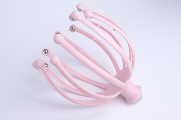 Close up of a pink head, scalp massage isolated on a white background