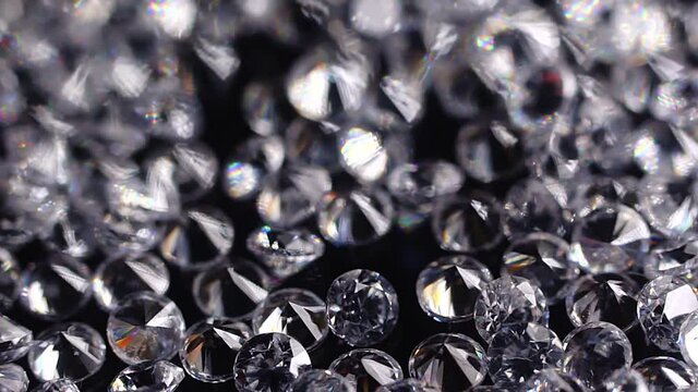 a large number of small faceted expensive cut diamonds on a black background