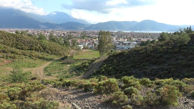 Fethiye, Turkey - 6th of March 2021: 4K Vicinal path and view on Fethiye city and the sea
