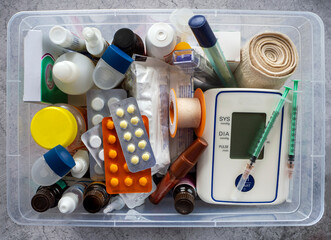 First aid kit with medicines, tonometer, thermometers, dressings, syringes, inhalers and medical...