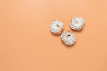 Eclairs ring with cream on a pastel yellow background. Top view, flat lay, copy space. Minimal composition.