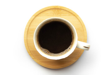 Cup of black coffee on wooden saucer on white background.
