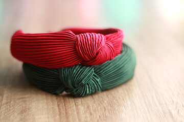 Red and green headband on wooden background. Selective focus. 