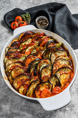 Traditional homemade vegetable ratatouille baked in dish. Gray background. Top view