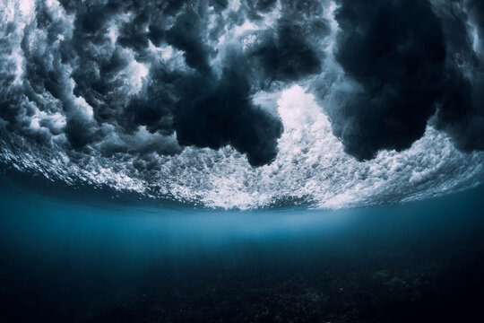 Wave underwater with foam, bubbles and sun light. Transparent ocean in underwater © artifirsov