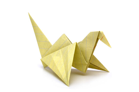 Origami yellow paper bird on white