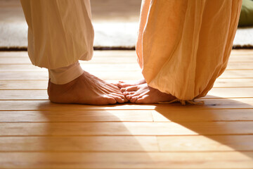 Bare feet of a man and a woman doing yoga as a couple