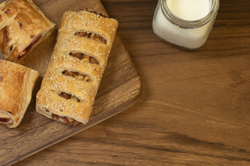 puff pastry dessert with glass of milk on wooden background