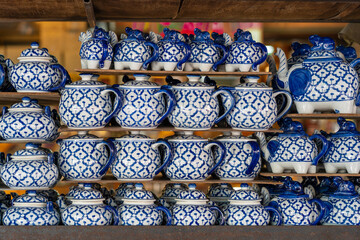 Many colorful tea set on stall for sale in local street market in Thailand. Close up