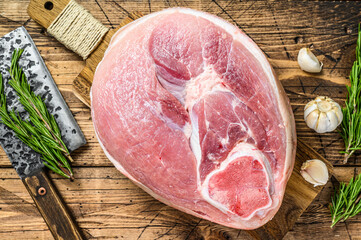 Raw pork ham cut. Leg meat. Wooden background. Top view