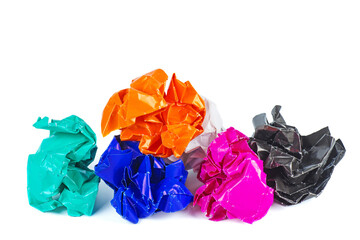 Clumps of crumpled colored paper on a white background