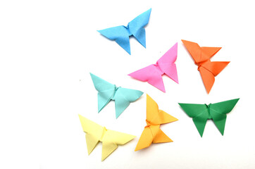 Group of origami paper butterflies on white